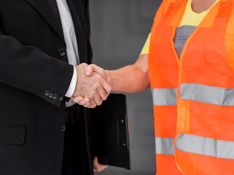 Commercial Structural Support Contractors in New York - A Woman Contractor Shaking Hands with a Business Owner