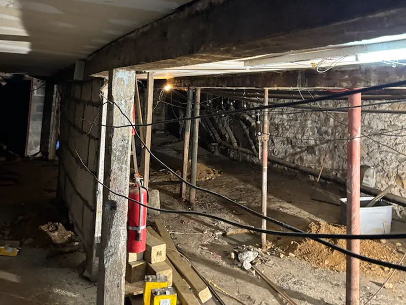 Trusted Commercial Foundation Repair Contractors in New York -- A Picture of a Zavza Seal LLC Tech Working on a Foundation